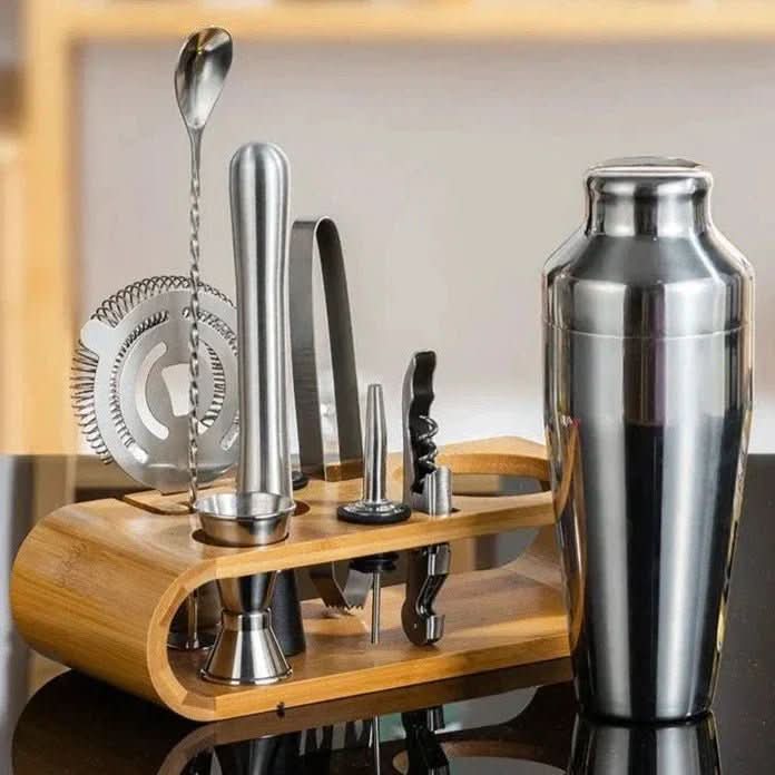 Silver 10-piece cocktail shaker set displayed in a bamboo storage stand.