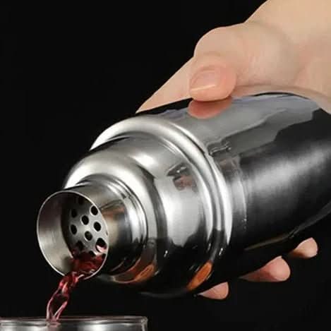 Cocktail being poured through the built-in shaker strainer.