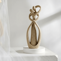 Sand intertwined couple sculpture in soft daylight