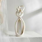Sand white intertwined couple sculpture in soft daylight