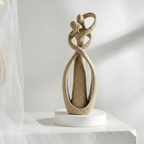 Abstract resin sculpture in a beige or white finish, lifestyle view.