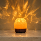 Brown ambient night light projecting warm amber ripples on a travertine console
