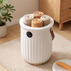 Beige aroma towel warmer bucket filled with rolled towels beside its lid