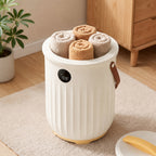 White aroma towel warmer bucket filled with rolled towels beside its lid
