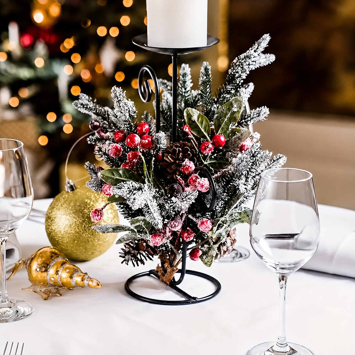 Artificial cedar and berry sprigs styled around a separate candleholder
