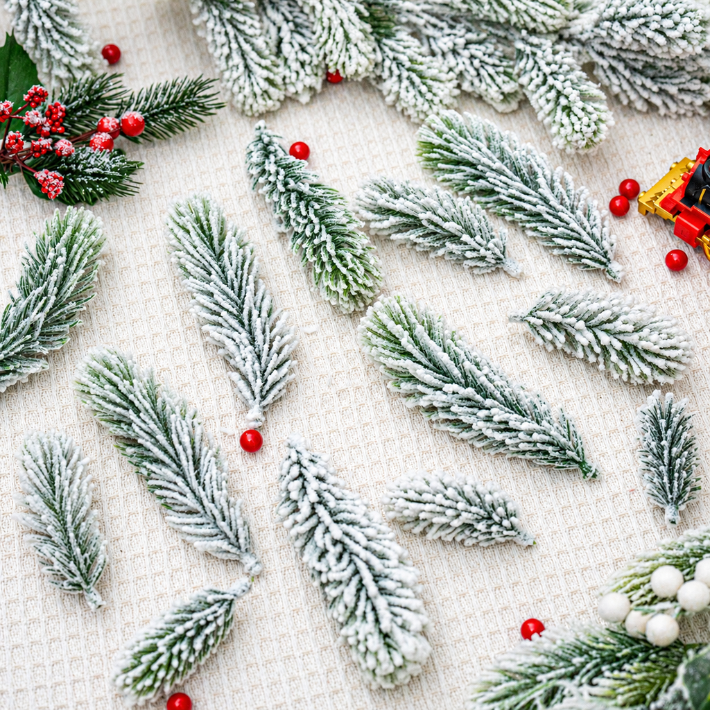 Loose snowy artificial cedar branches on a fabric background