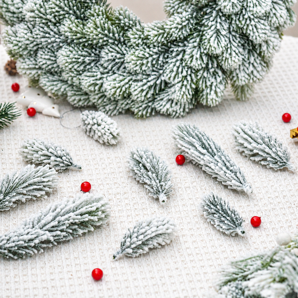 Snow flocked artificial cedar sprigs beside a separate wreath styling example