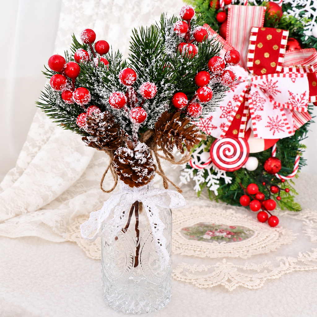 Artificial cedar and red berry sprigs in a small vase beside gift styling