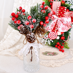 Artificial cedar and red berry sprigs in a small vase beside gift styling