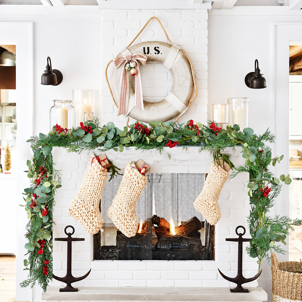 Artificial Christmas garland arranged around a fireplace with knitted stockings.
