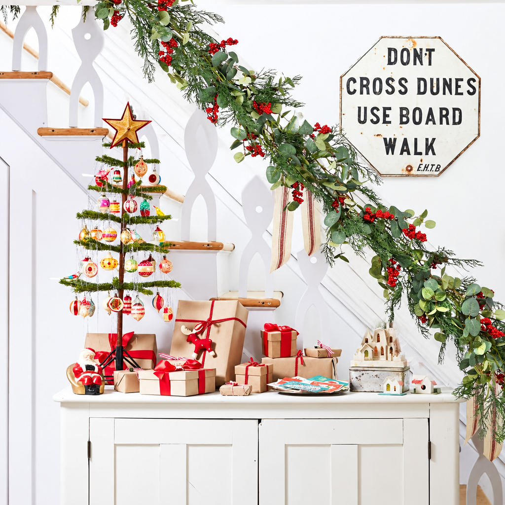 Artificial Christmas garland draped over a pale stair railing.
