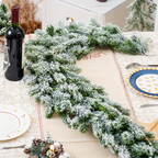 Snow flocked artificial evergreen garland arranged along a dining table