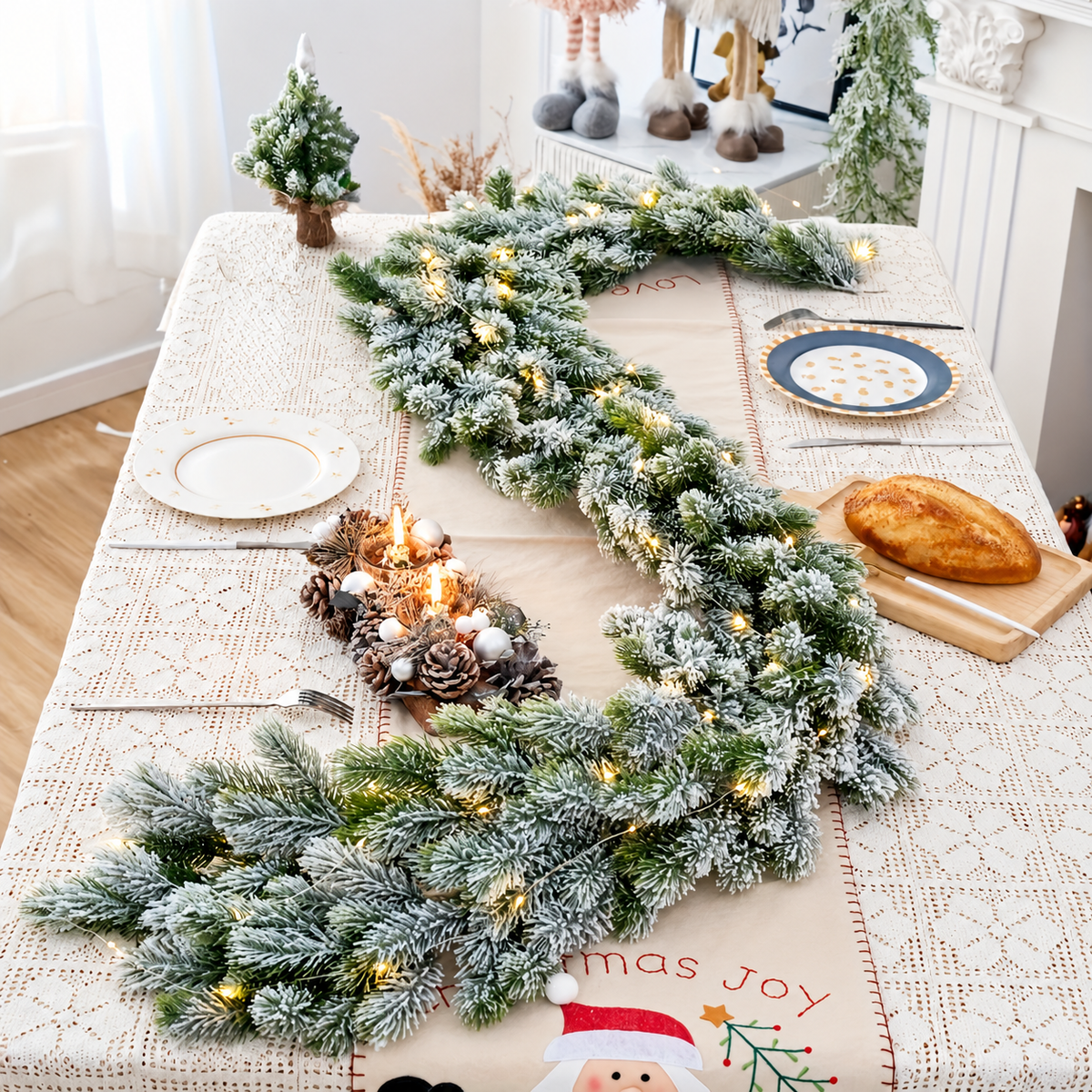 Artificial snow flocked garland in a table setting shown with separate candle styling