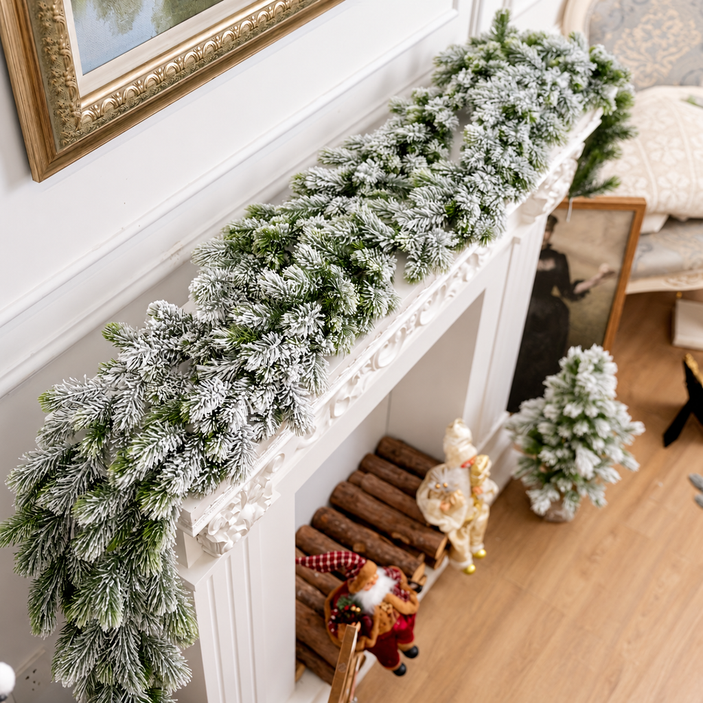 Artificial snow flocked garland viewed along a decorative fireplace mantel