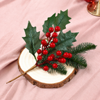 Artificial holly pine and red berry pick on a wood slice in a tabletop display