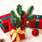 Artificial holly berry pick as a decorative accent beside wrapped Christmas gifts