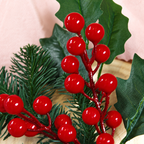 Close view of shiny red berry details holly leaves and artificial pine needles