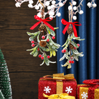 Red bow artificial mistletoe ornaments hanging above a wrapped gift