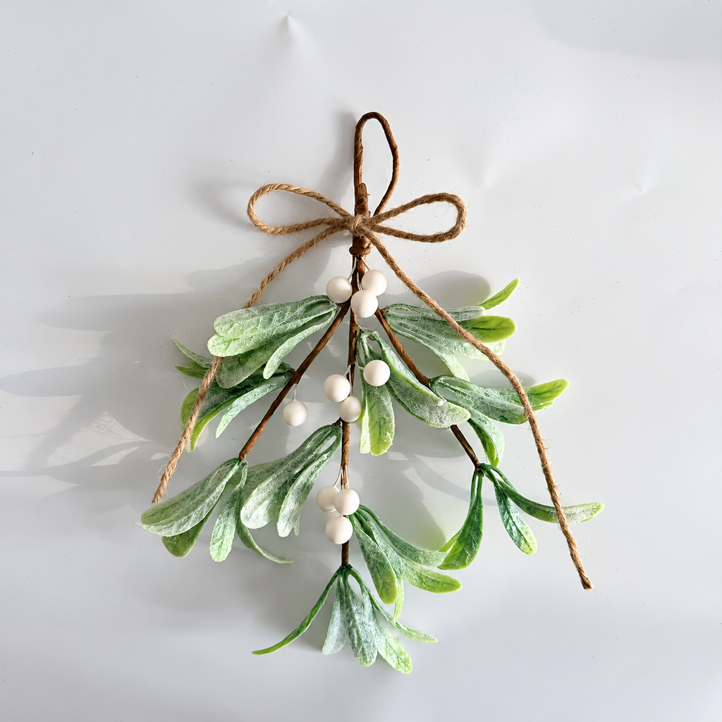 White berry artificial mistletoe hanging sprig with frosted foliage and twine bow