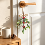 Artificial mistletoe ornament hanging from a cupboard knob