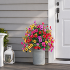 Artificial outdoor flowers in a gray planter beside a white front door