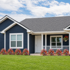 Artificial outdoor flowers lining a blue American home and front lawn