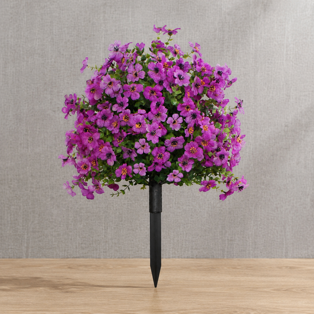 Purple artificial outdoor flowers on linen and natural oak surfaces