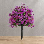 Purple artificial outdoor flowers on linen and natural oak surfaces