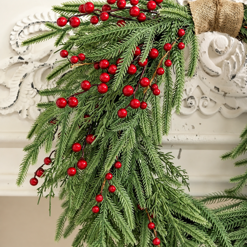 Close up of artificial pine foliage red berries and the wrapped hanging point