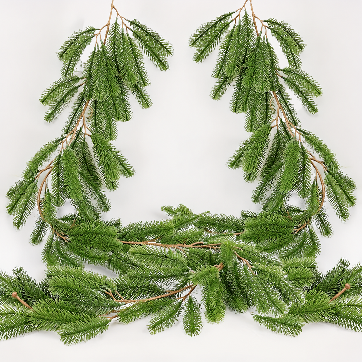 Artificial pine garland draped loosely showing branches and central stems