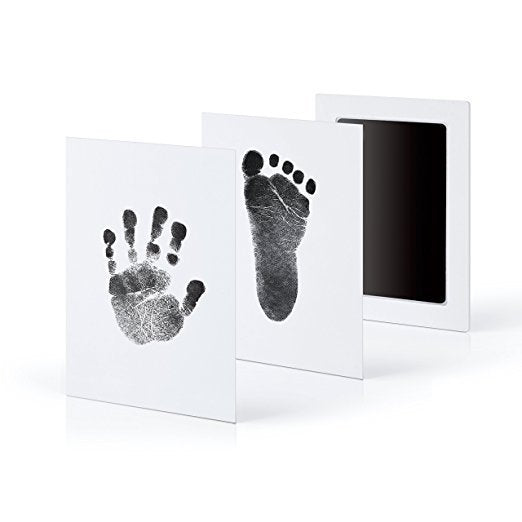 Baby handprint kit with black hand and foot impressions on white cards