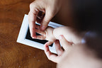 Baby handprint kit being used with adult assistance