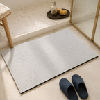 White quick dry bath mat with intersecting gray arcs beside a ribbed glass shower.