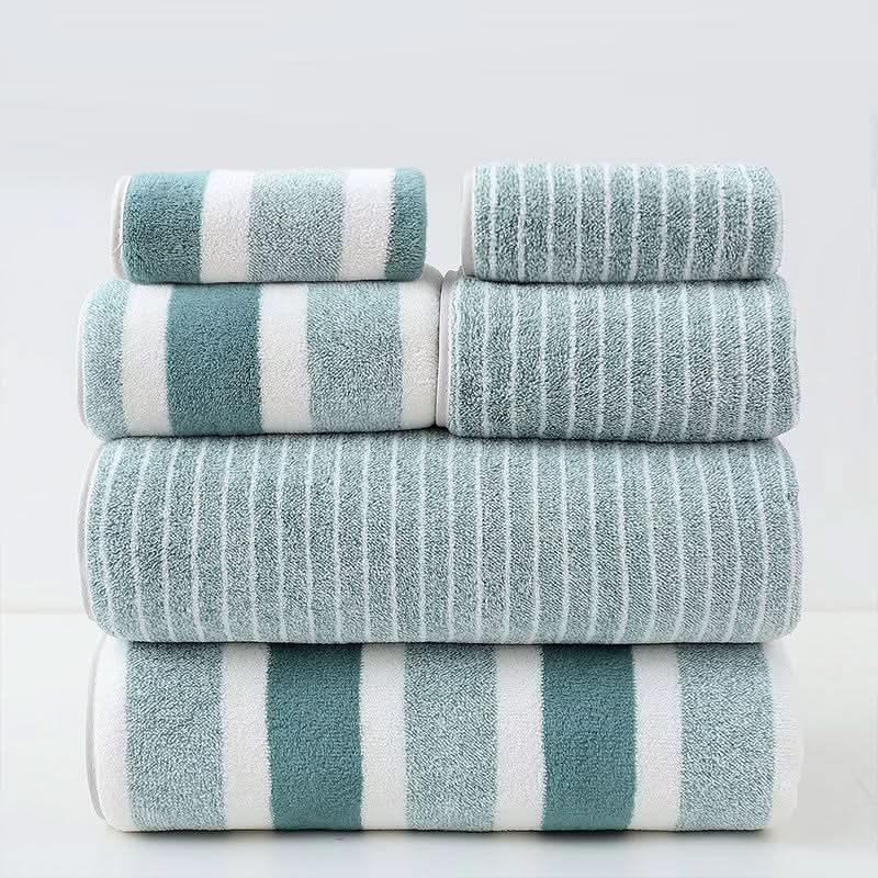 Bath towel set in green and white stripes stacked in eight pieces.