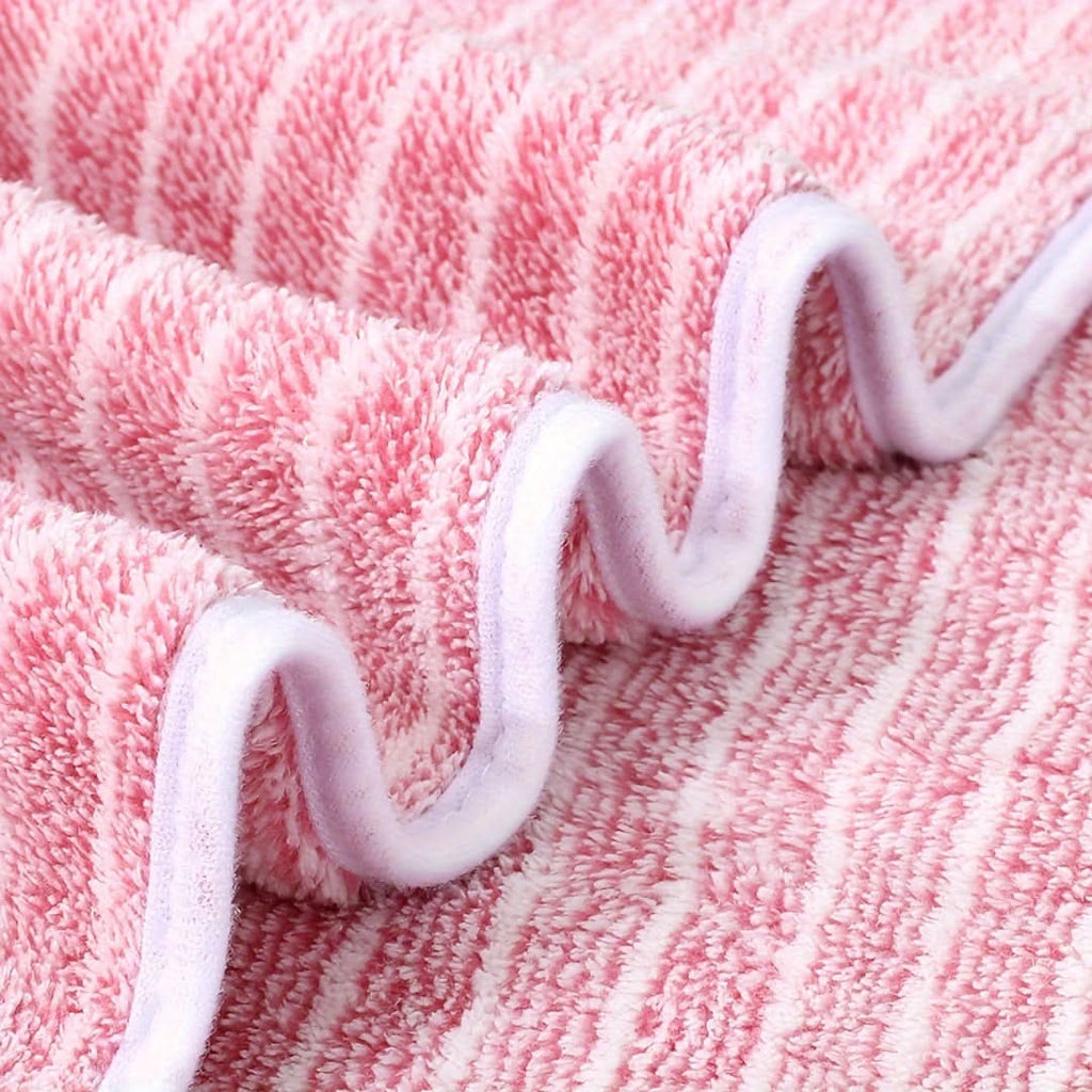 Bath towel set shown close up in pink stripes with white bound edges.