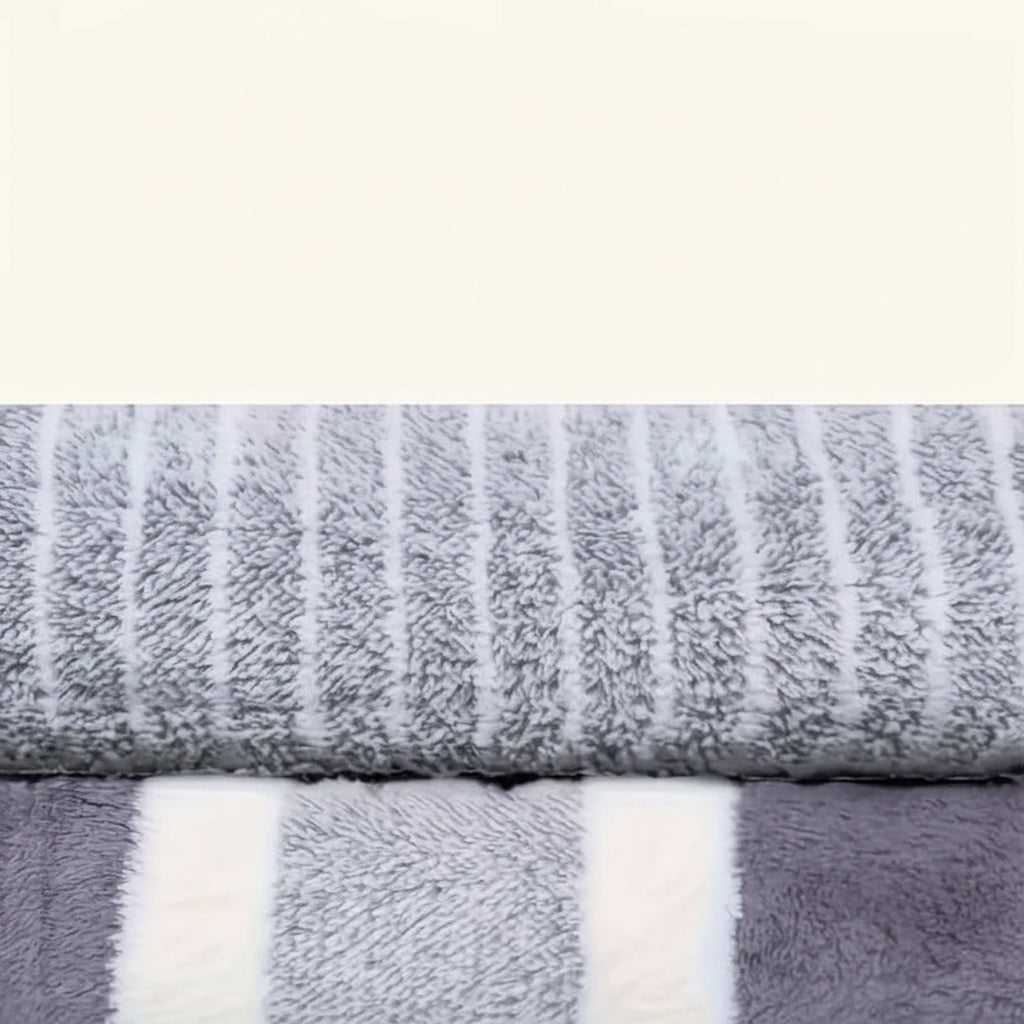 Bath towel set shown close up in gray stripes with a woven texture detail.