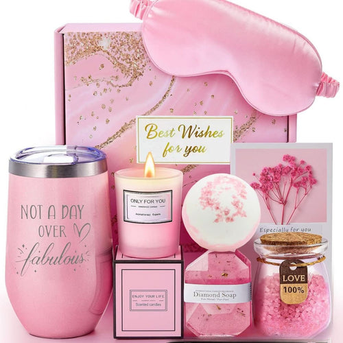 Pink bath and aromatherapy gift set with eye mask, tumbler, candle, bath bomb, salts, and soap.