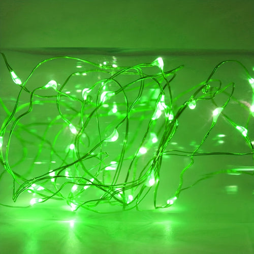 Green fairy string lights illuminated in a decorative strand