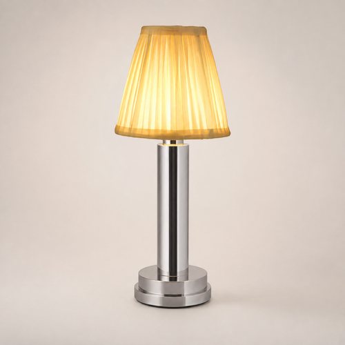 Silver table lamp with a pleated cream shade and silver-tone cylindrical base on a plain background.