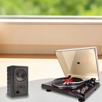 Turntable beside an external speaker in a listening setup