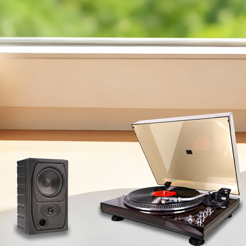 Turntable beside an external speaker in a listening setup