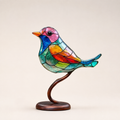 Colorful acrylic bird statue on a curved wood branch and oval base.