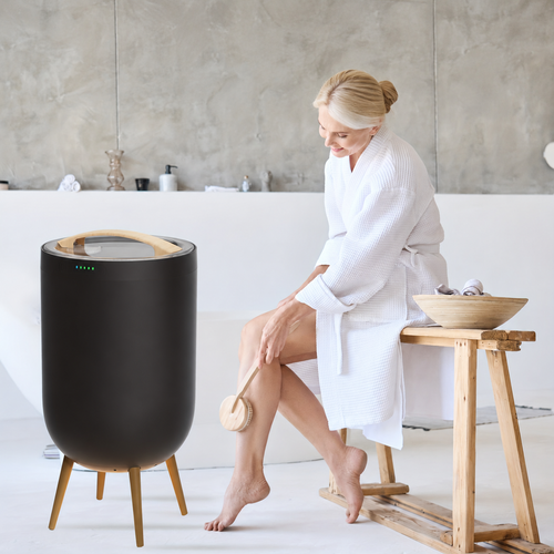 Black towel warmer beside a bathtub in a bright bathroom