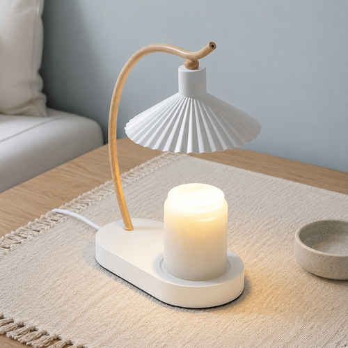 White candle warmer lamp with a curved wood arm warming a plain jar candle on a light oak table.