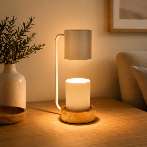 White candle warmer lamp glowing beside home decor.