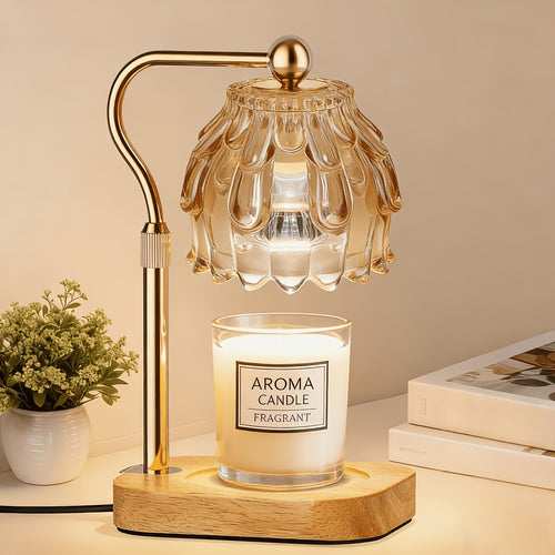 Gold glass candle warmer lamp with a jar candle on a wood base.