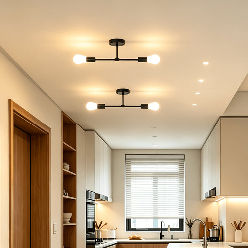 Pair of black two bulb ceiling lights installed along a hallway.