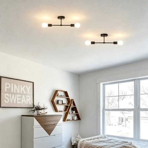 Pair of black two bulb ceiling lights above a bright bedroom.