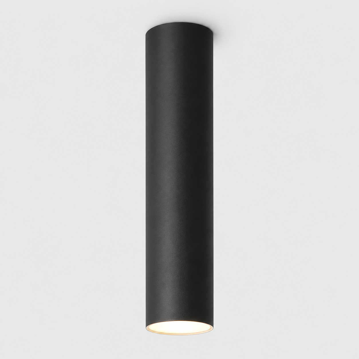 Black ceiling spotlight shown on a light gray background with warm downward illumination.