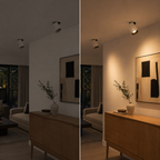 A split-screen comparison of a modern room interior, showing the same space under two lighting conditions: a cooler, unlit view on the left and a warm, illuminated view on the right. The scene includes a wooden console table, a beige sofa, a framed abstract wall art piece, a vase with branches, and a wall-mounted spotlight.